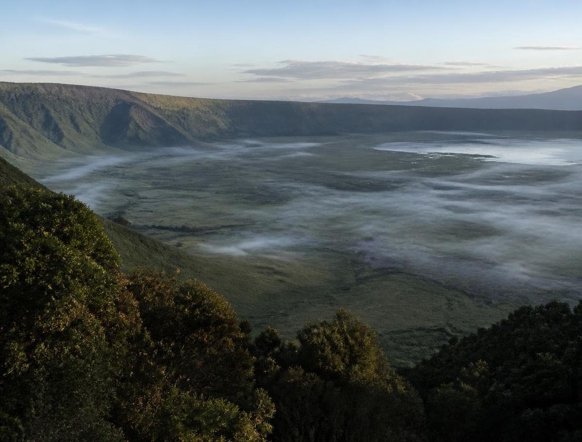 View down into the Ngorongoro Crater with mist lying on the crater floor