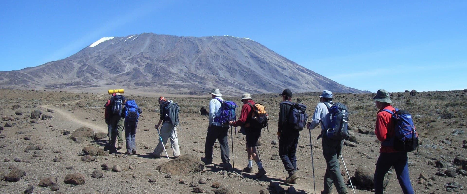 Trekkers crossing the bare upper slopes of Kilimanjaro