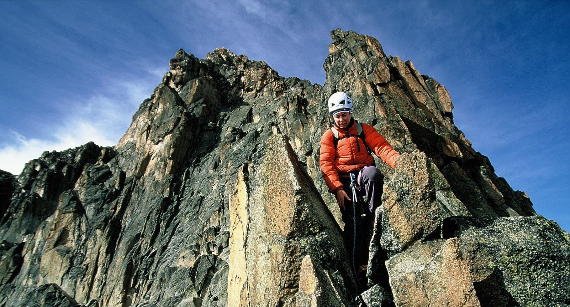 A climber on a steep rock face on Mount Kenya